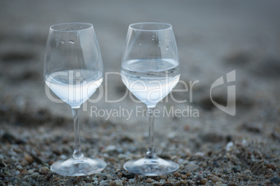 Two glasses of water on the beach