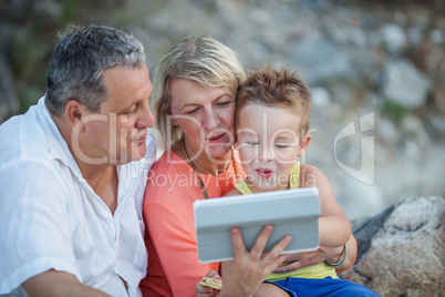 Grandparents and grandson with tablet PC outdoor