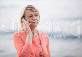 Blond woman having a phone talk outdoor