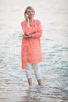 Woman talking on mobile phone at the seaside