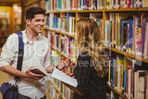 Couple with books looking at each other