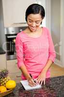 Smiling brunette writing on note pad