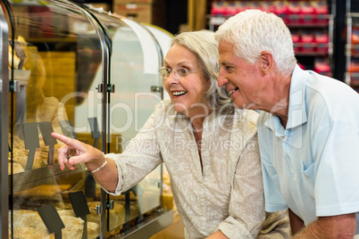 Senior couple pointing puddings