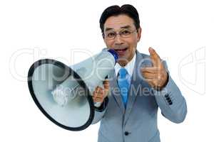 Asian businessman talking through megaphone