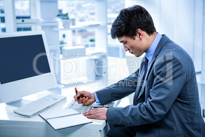 Focused businessman highlighting a document