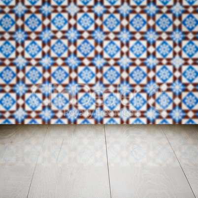 Wood table top and blur vintage ceramic tile pattern wall