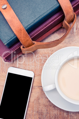 Smartphone with coffee and diaries