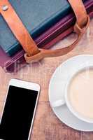 Smartphone with coffee and diaries