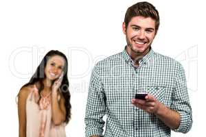 Smiling couple with smartphones