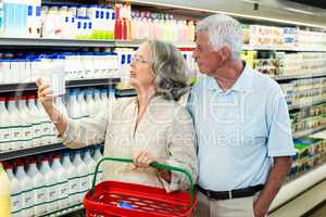 Senior couple buying milk