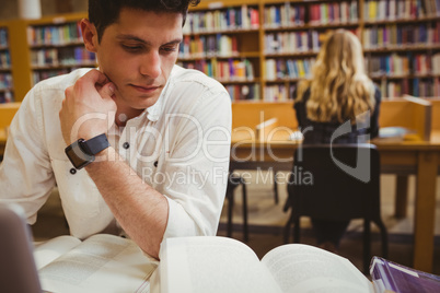 Focused student using his laptop while working Focused student using his laptop while working