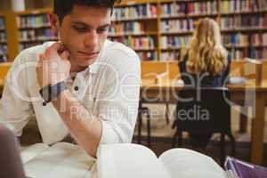 Focused student using his laptop while working