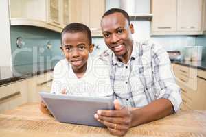 Father and son using tablet