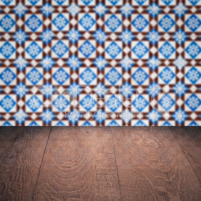 Wood table top and blur vintage ceramic tile pattern wall