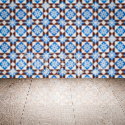 Wood table top and blur vintage ceramic tile pattern wall