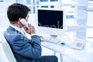 Businessman using his telephone