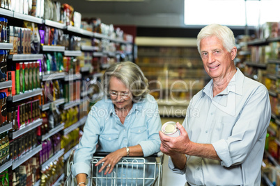 Smiling senior couple buying food