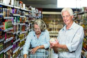 Smiling senior couple buying food