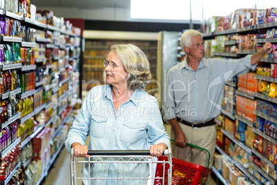 Smiling senior couple buying food