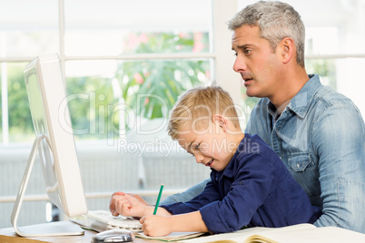 Father and son at the desk