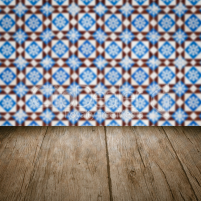 Wood table top and blur vintage ceramic tile pattern wall