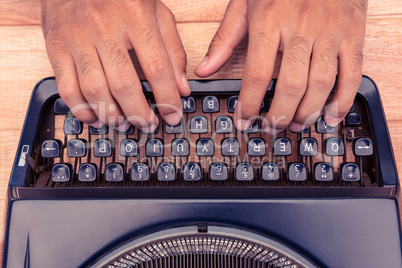 Cropped image of businessman typing on typewriter