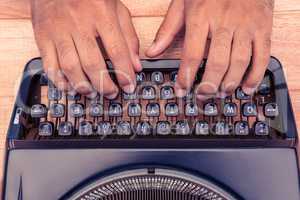 Cropped image of businessman typing on typewriter