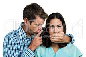 Man covering his girlfriends mouth