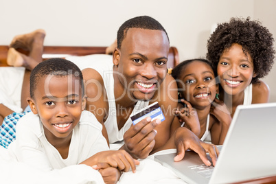 Happy family lying on the bed