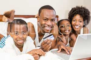 Happy family lying on the bed