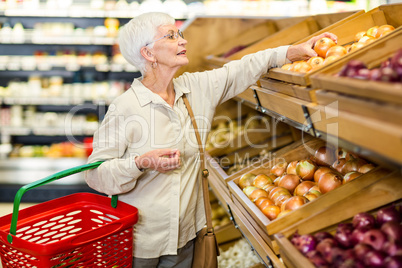 Senior woman picking out some vegetables