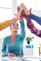 Business woman doing high five with team in creative office
