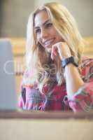 Smiling female student using laptop