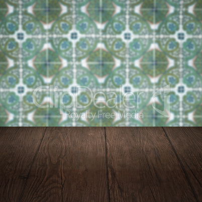 Wood table top and blur vintage ceramic tile pattern wall Wood table top and blur vintage ceramic tile pattern wall