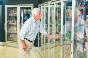 Smiling senior man buying food