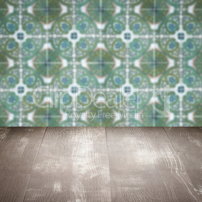 Wood table top and blur vintage ceramic tile pattern wall