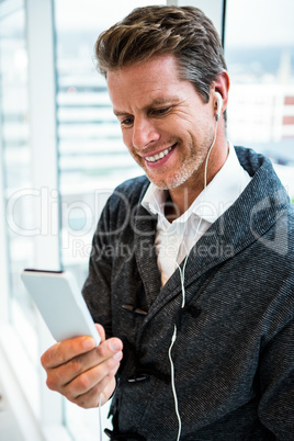 Man wearing headphones using mobile phone