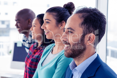 Cheerful business team standing in row