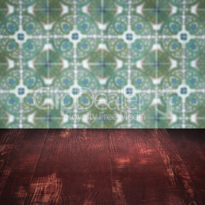 Wood table top and blur vintage ceramic tile pattern wall