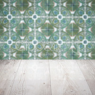 Wood table top and blur vintage ceramic tile pattern wall