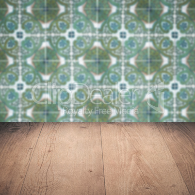 Wood table top and blur vintage ceramic tile pattern wall