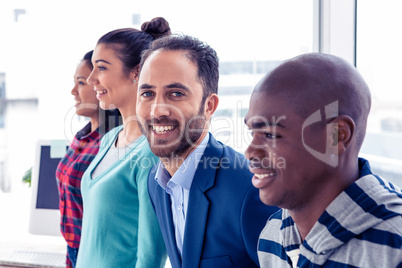 Portrait of smart businessman with colleagues