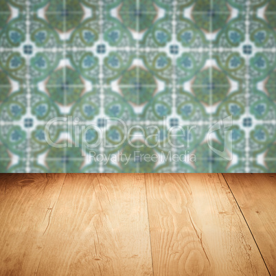 Wood table top and blur vintage ceramic tile pattern wall