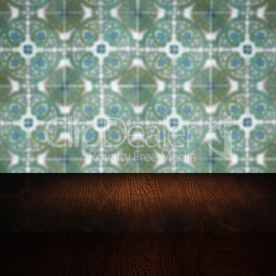 Wood table top and blur vintage ceramic tile pattern wall