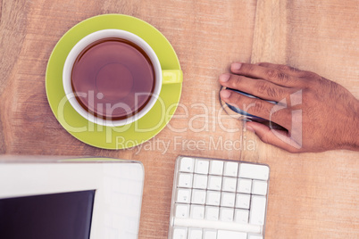Businessman using mouse while working at table