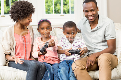 Smiling family sitting on the couch together