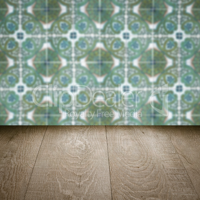 Wood table top and blur vintage ceramic tile pattern wall