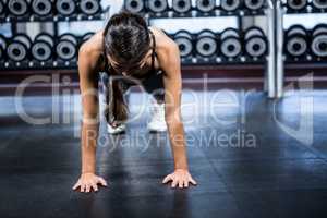 Fit woman doing push ups exercises