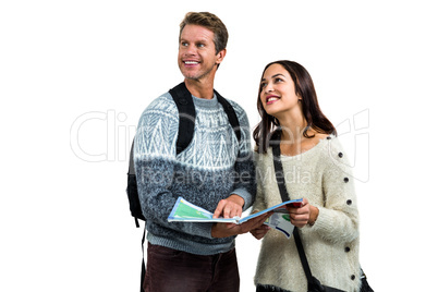 Happy couple using map while traveling