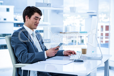 Asian businessman using his phone